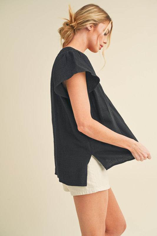 Aemi + Co Embroidered Trim Side Slit Notched Short Sleeve Blouse in Black in Black - us.meeeshop