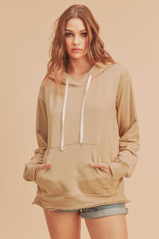 Aemi + Co Raw Hem Kangaroo Pocketed Drawstring Hoodie in Oatmeal - us.meeeshop